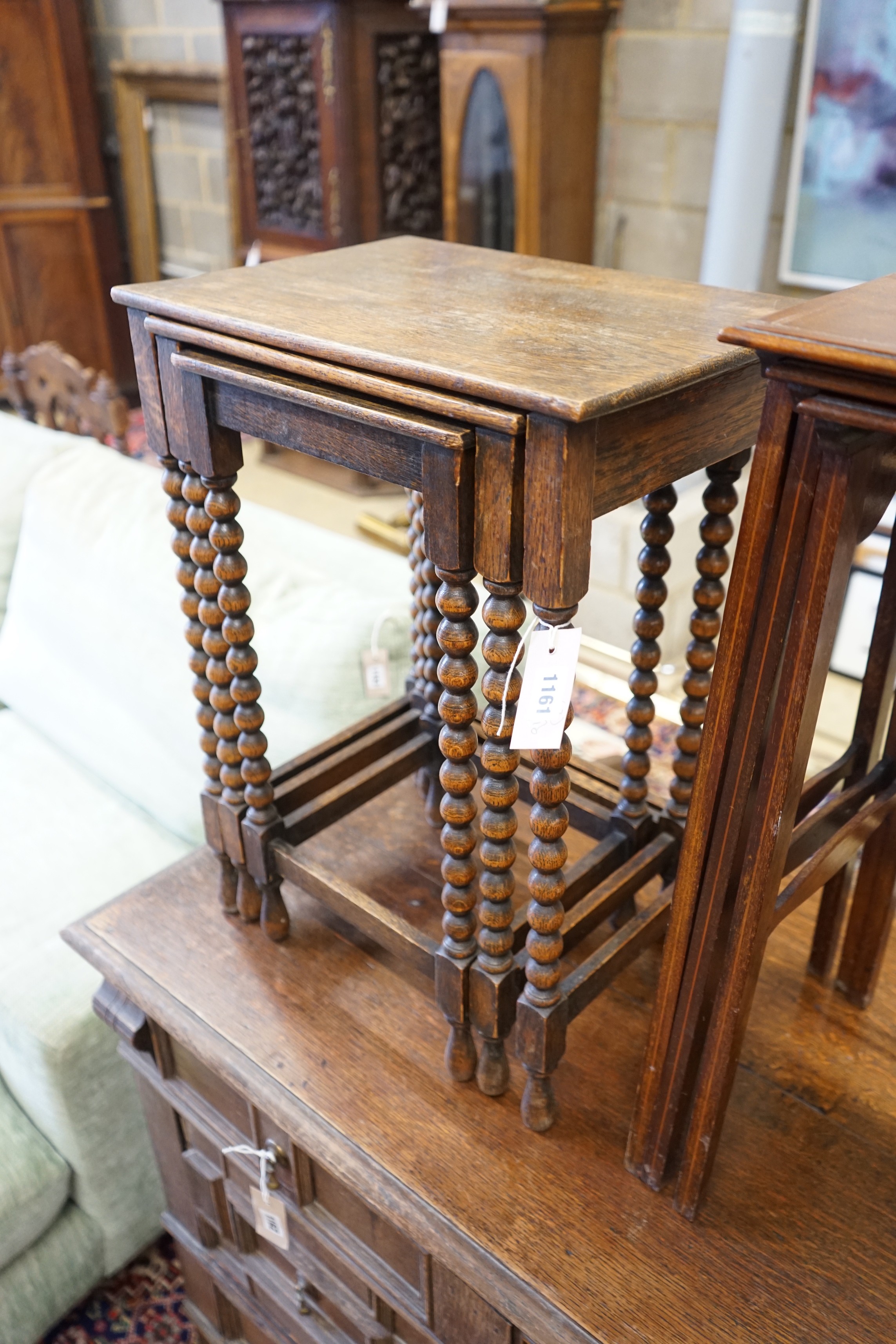 A nest of three Edwardian mahogany tea tables, height 61cm, a nest of three oak tea tables and an octagonal carved occasional table